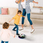 A child happily playing with the glowing Hover LED Ball indoors, showcasing its vibrant lights.