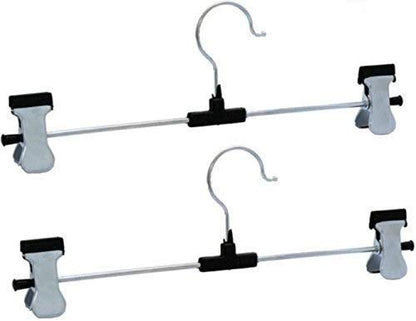 Organized wardrobe section showcasing clothes neatly hung on stainless steel hangers.