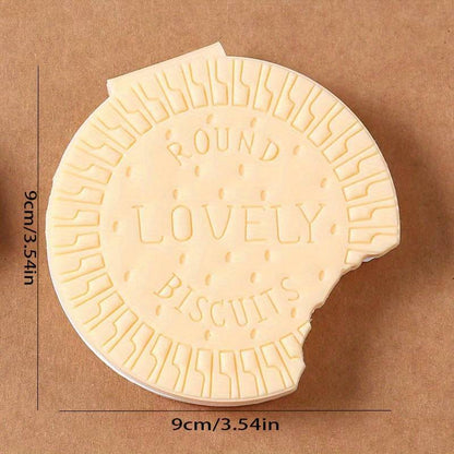 A child's hand holding the fun biscuit notebook, perfect for early learning and creative writing.