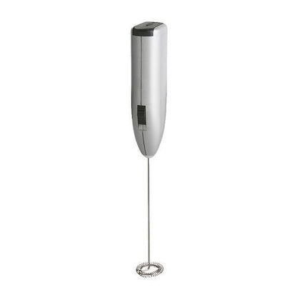 Close-up of the electric milk frother creating creamy foam in a mug.