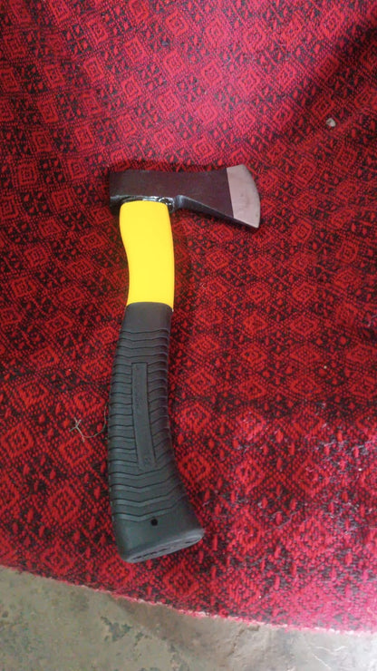 Hatchet axe demonstrating its use for clearing brush in a garden setting.