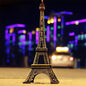 Antique finish Eiffel Tower statue on a white background.