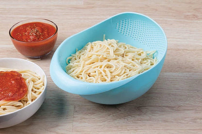 Large plastic rice bowl strainer in use, showing grains being washed.