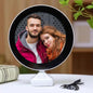 LED Magic Mirror Photo Frame glowing with a picture inside, on a white table.
