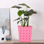 Square dotted railing planter for a single plant, enhancing a modern balcony.