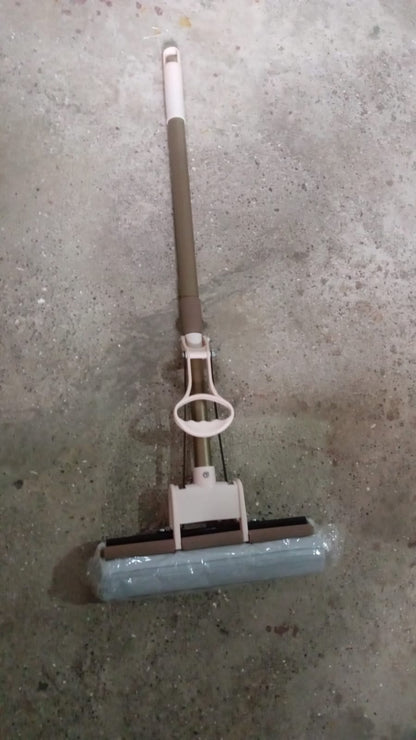 The sponge mop effectively cleaning a tiled floor, demonstrating its dirt removal capabilities.