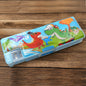 Front view of a vibrant plastic kids pencil case with cartoon print and two compartments.