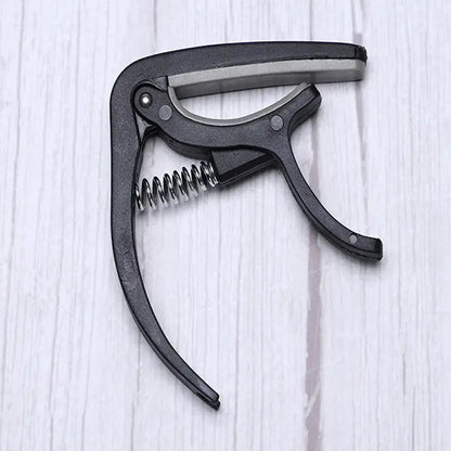 Detail of the Wagtail guitar capo's protective soft pad, preventing instrument damage.