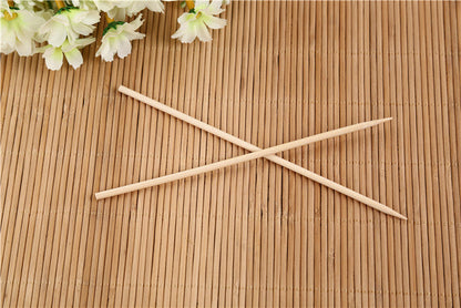 Bundle of natural bamboo skewers tied with string for display.