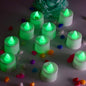 Green flameless LED tealights glowing softly on a dark surface.