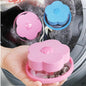 Floating washing machine lint catcher with a pink flower detail.