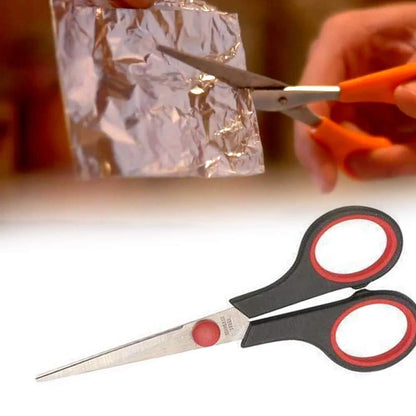 Close-up of the ergonomic handle and sharp blade of a Quickslice scissor.