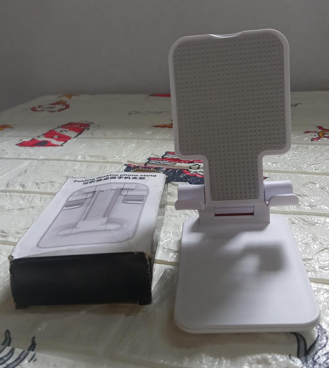 Convenient mobile stand holding a smartphone, shown in a home setting.
