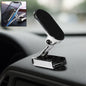 A 360° rotating magnetic car phone holder made of metal, shown on a car dashboard.