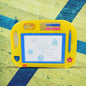Close-up of a child drawing on the Magic Sketch Slate with the attached stylus pen.