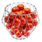 Elegant stainless steel wire foldable fruit basket displayed on a kitchen counter.