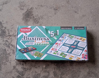 Close-up of plastic money, game board, and pieces for the business learning game.