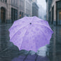 A closed Magic Umbrella with a subtle blossom pattern, ready for rain surprises.