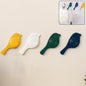A set of four elegant self-adhesive bird hooks displayed against a clean wall.