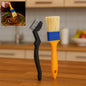 Two basting brushes, one with red handle and one with blue, for cooking and baking.