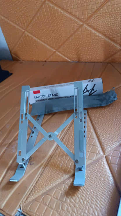 Laptop stand angled to ergonomic height to reduce neck and wrist strain