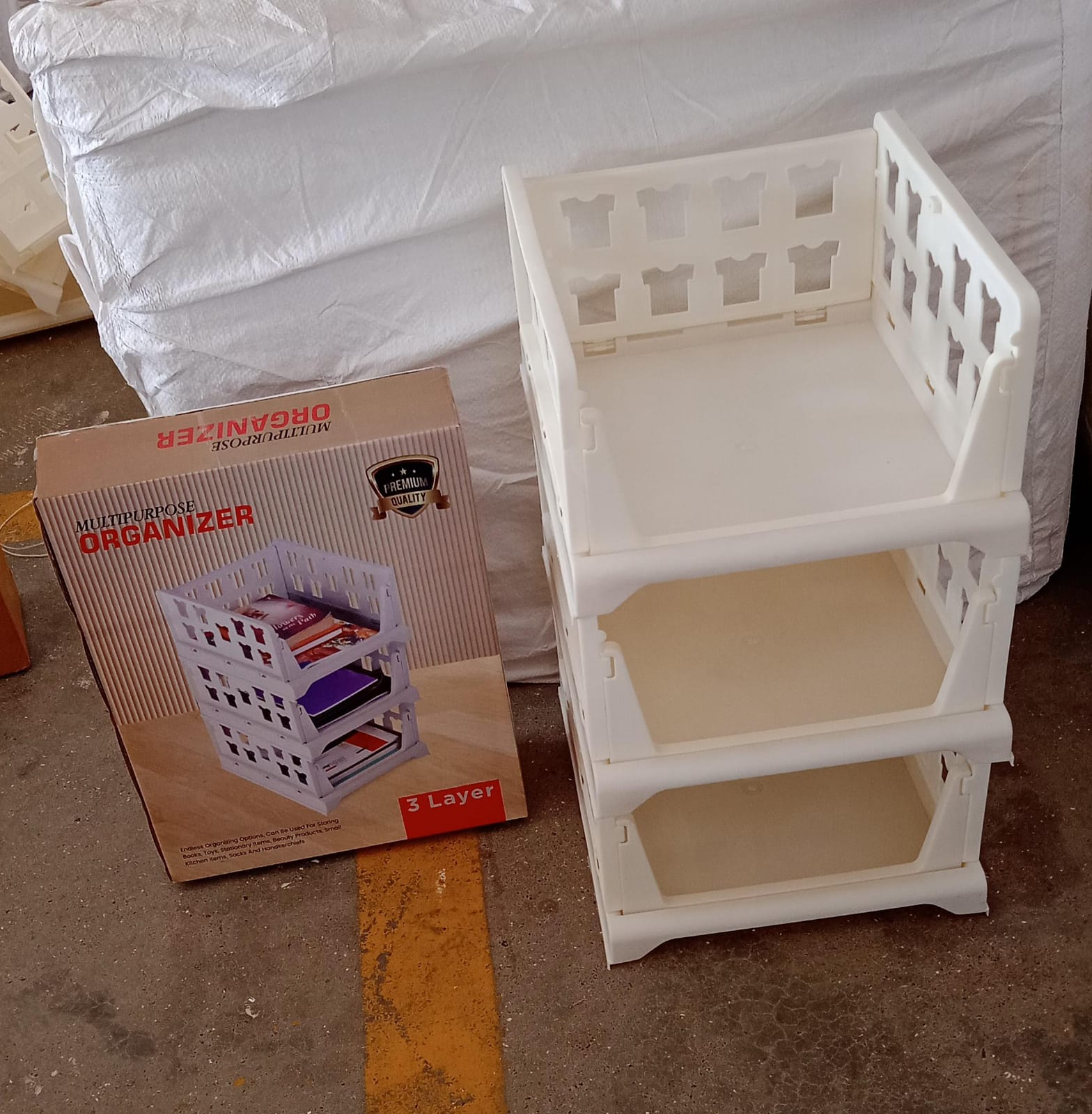 3-layer foldable storage cart, stackable for organizing various items.