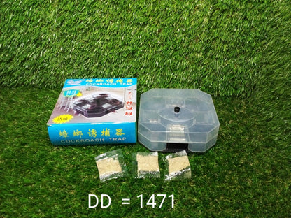 A blue box labeled "COCKROACH TRAP," a clear plastic trap, and three packets of bait are on a green artificial grass surface.