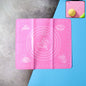 Non-stick silicone baking mat with measurement guides on a counter.