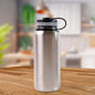 Silver stainless steel vacuum insulated water bottle with double wall keeping drinks hot or cold