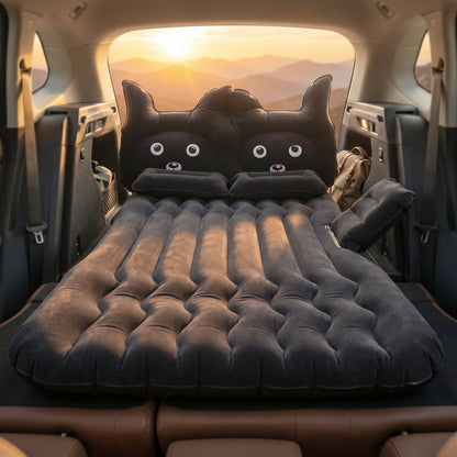 Black cat pillow on inflatable car mattress for comfort