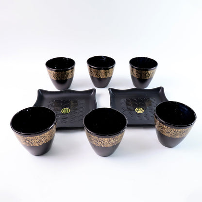 Stack of ceramic bowls and cups from the 8-piece collection by Indo Glow.