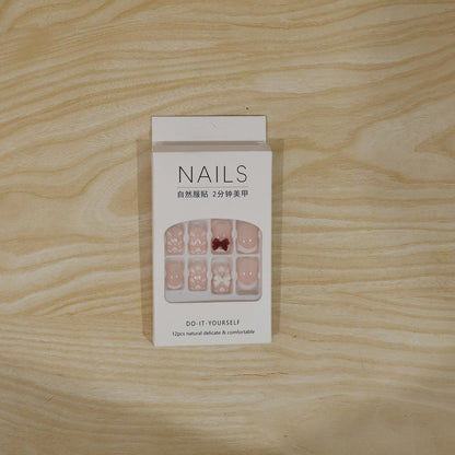 Model’s hand adorned with glamorous glitter 3D floral press-on nail tips for special events.