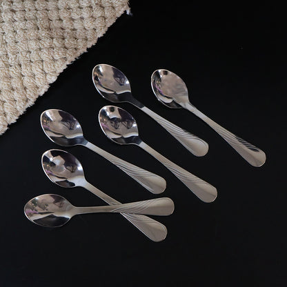 Single polished stainless steel dining spoon with mirror-like shine