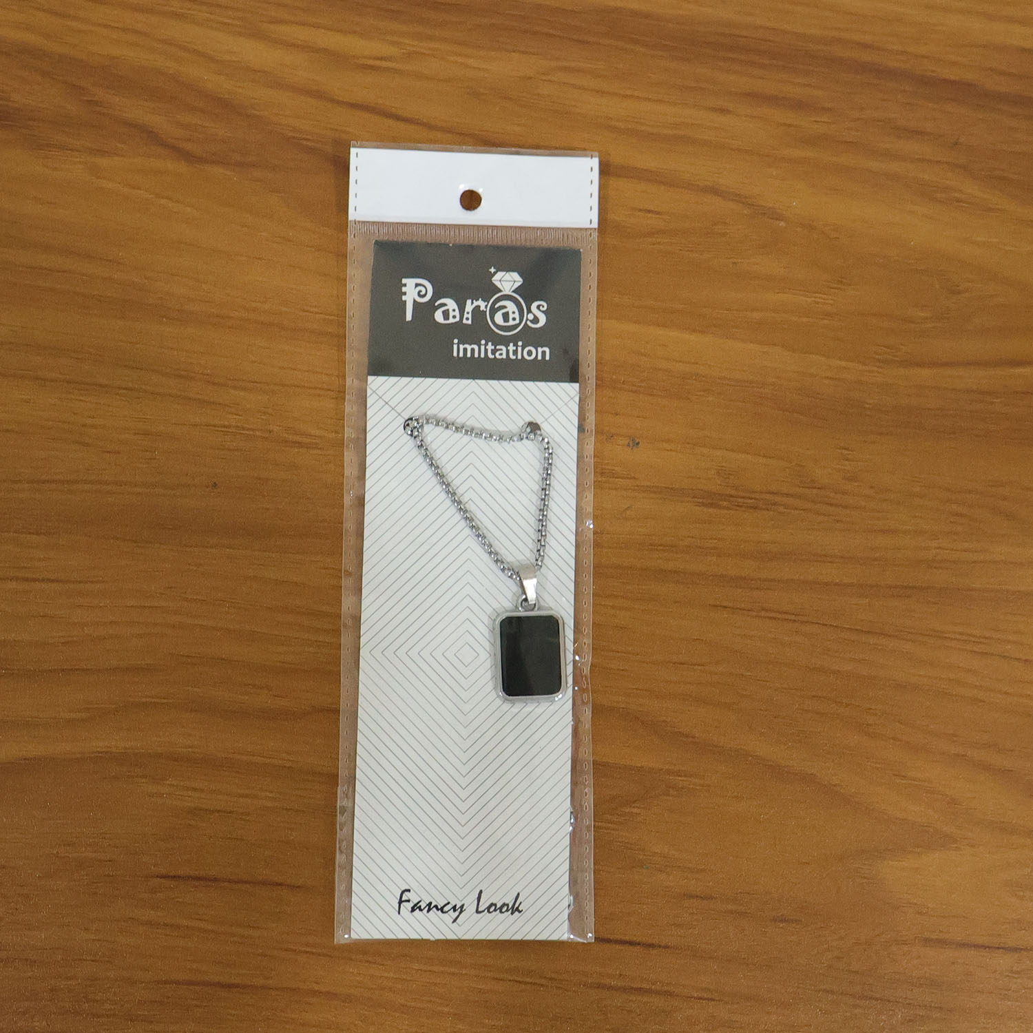 Model wearing men's stainless-steel pendant chain with black rectangular pendant necklace