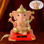 Solar-Powered Dancing Ganesha Idol with detailed gold accents on a decorative base