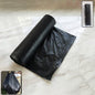 Heavy-duty black garbage bag roll, ideal for home waste disposal.