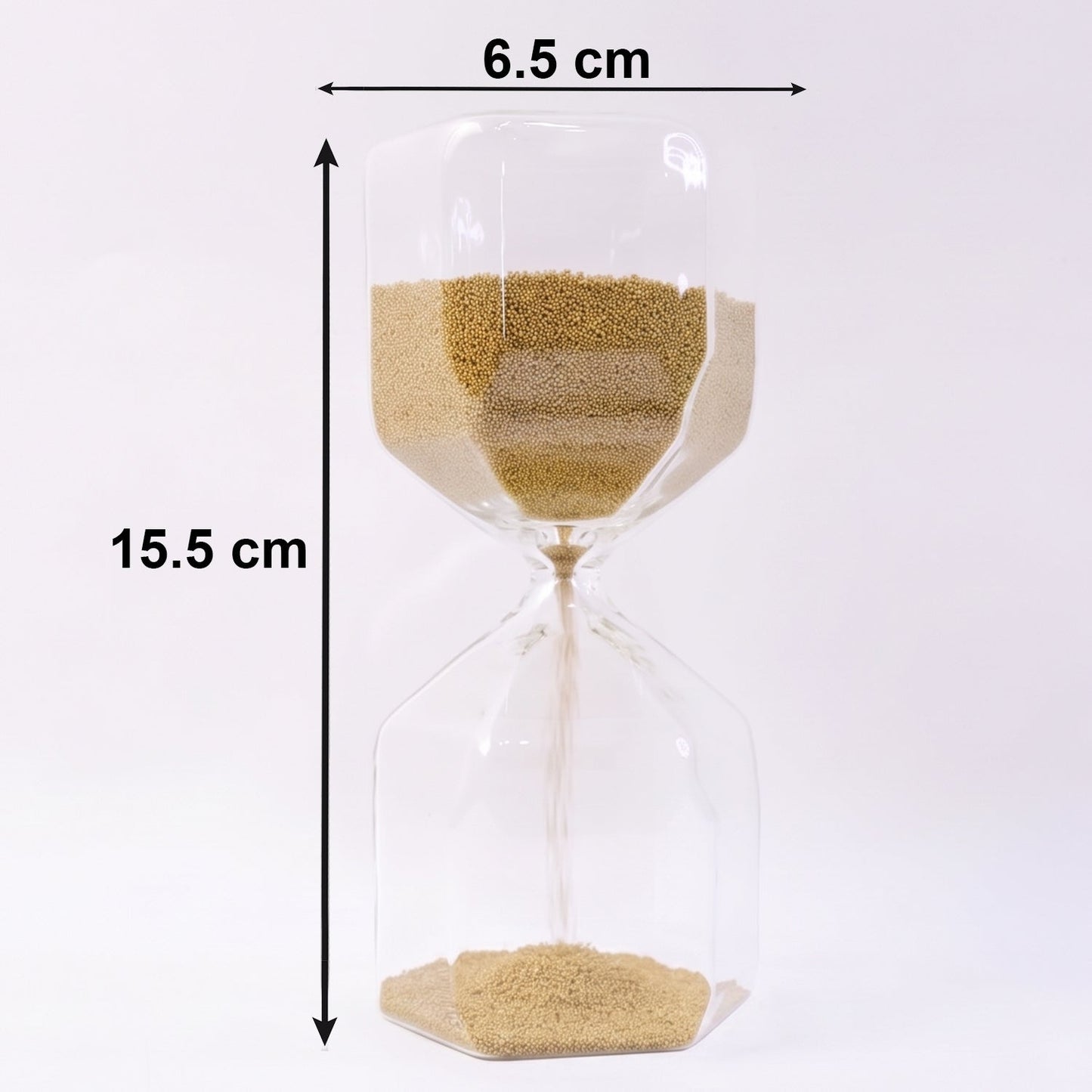 Smooth yellow sand flowing inside an elegant glass hourglass timer.