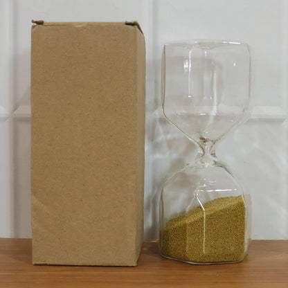 Clear glass 4-minute sand timer hourglass on a clean white background.