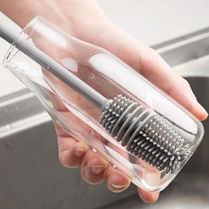 A bottle cleaning brush effectively cleaning the inside of a tall water bottle.