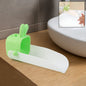 Cute bear-shaped silicone kids faucet extender on a modern bathroom sink.