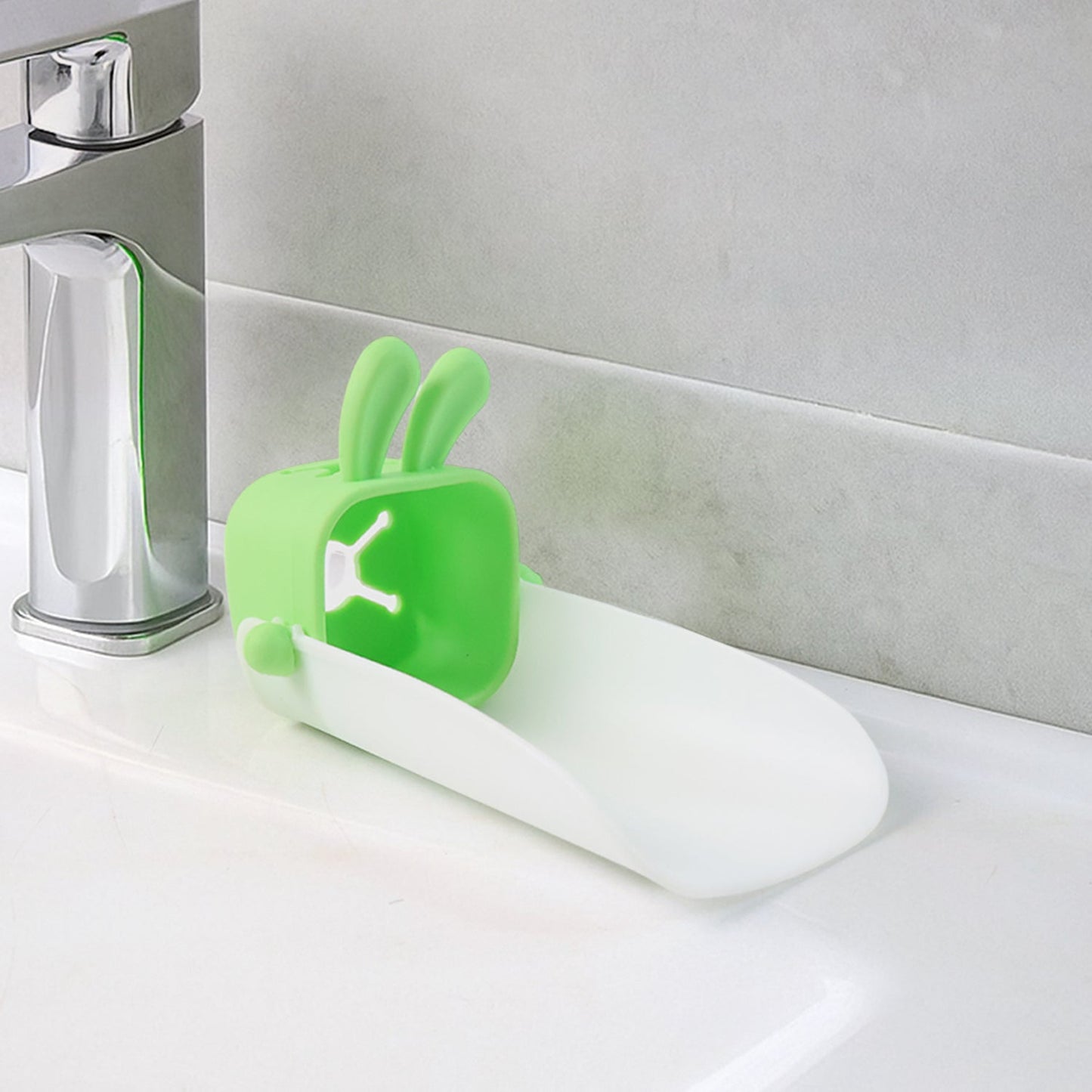 Hand demonstrating the flexible, durable silicone material of the faucet extender.