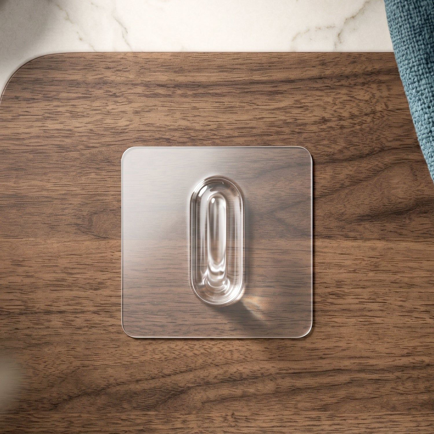 Side view of transparent adhesive wall hook demonstrating its design