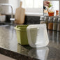 Multipurpose plastic storage container with lid shown with food items inside