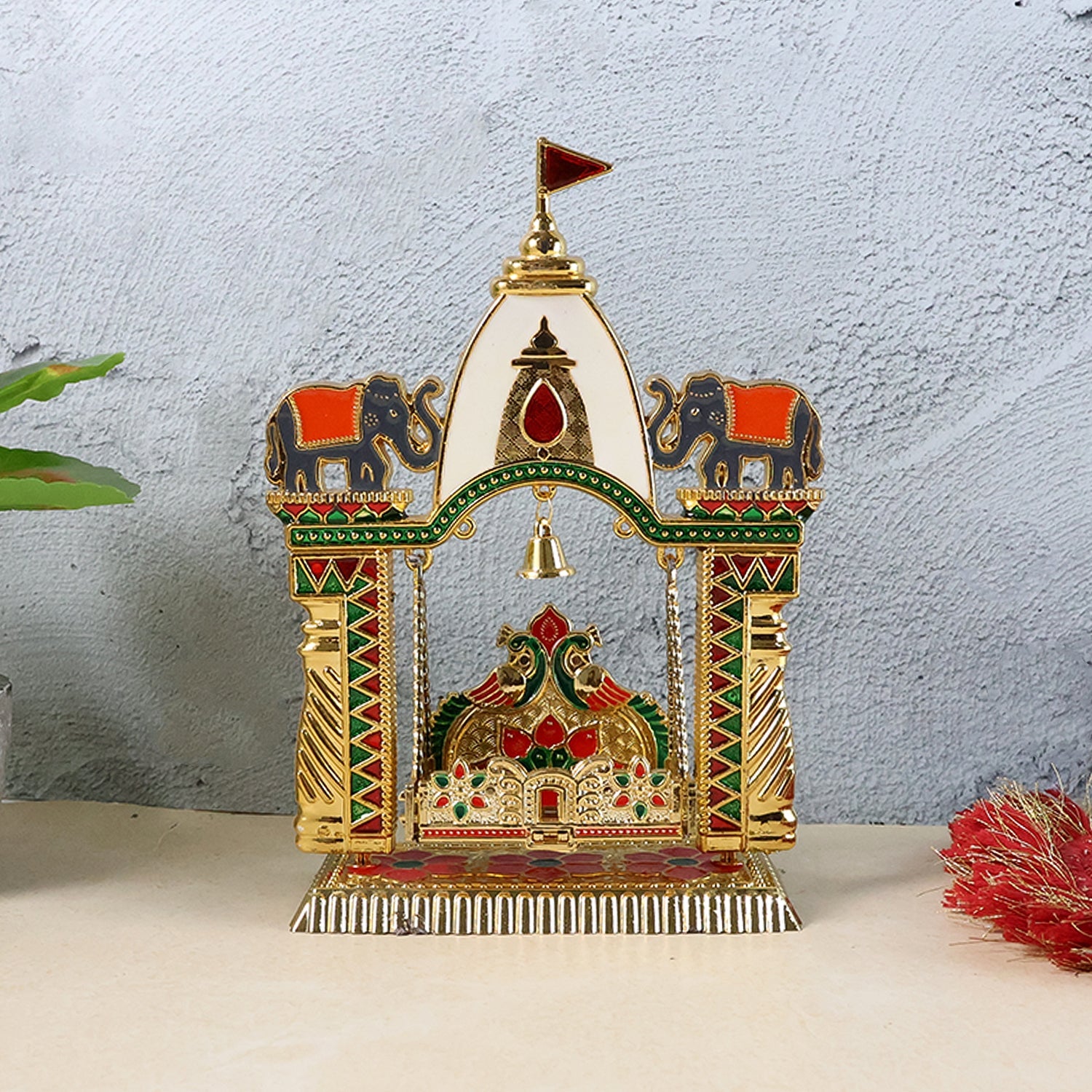 Festive pooja mandir swing with vibrant enamel and hanging bell