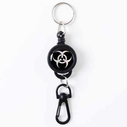 Durable retractable keychain securely clipped onto a fabric strap.