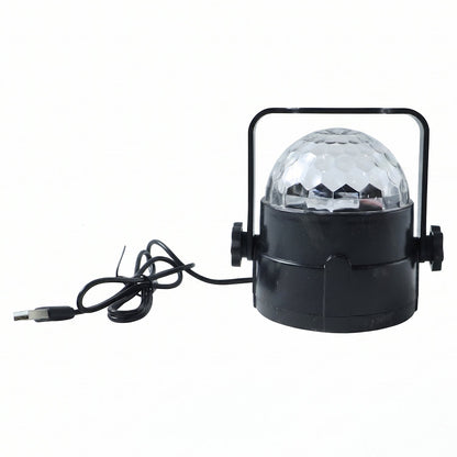 Hand holding the small USB powered star projector light, highlighting its compact size.
