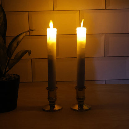 Pair of battery operated flameless LED taper candles glowing warmly during festival celebration