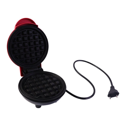 Golden brown waffles served on a plate next to the Mini Waffle Maker.