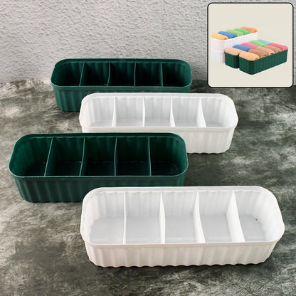 Four 5-compartment drawer organizers neatly stacked, storing socks and underwear.