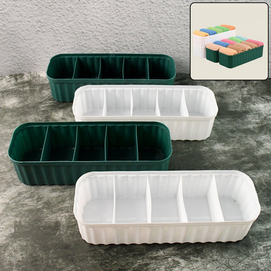 Four 5-compartment drawer organizers neatly stacked, storing socks and underwear.